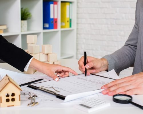 Hispanic architectural team planning over new project in office